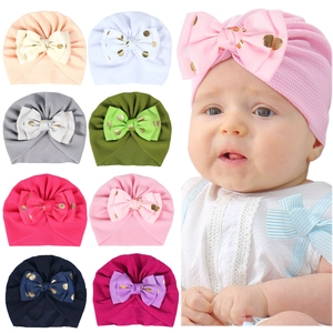 Newborn baby turban hat with gold polka dot bow and waffle texture in multiple colors