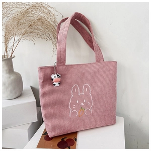 Pink corduroy tote bag featuring rabbit embroidery and a cute cow pendant accessory