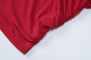 Detail of red elastic fabric showing professional ruching craft and double stitching