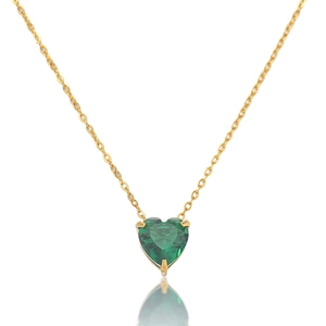 Detail of emerald green heart pendant necklace featuring gold claw-set zircon gemstone