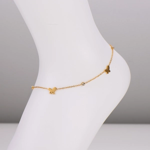 Minimalist gold stainless steel butterfly anklet with sparkling clear crystals on model