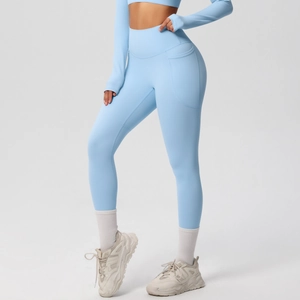 Close-up of light blue high-waisted yoga pants with functional side pockets and elastic fabric