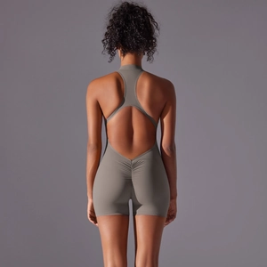 Detail view of the scrunch butt and open back design on a grey yoga bodysuit