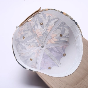 Detail view of the baseball cap's inner lining with floral patterns and sweatband