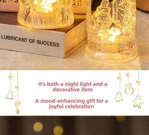 Close-up of clear acrylic LED Holy Family nativity ornaments with warm yellow light