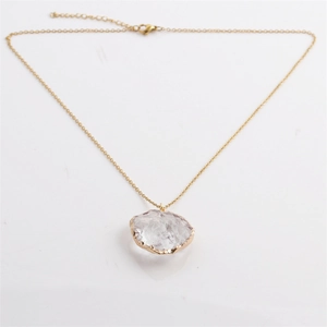 Golden twist chain necklace featuring a faceted heart moon semi-precious stone pendant