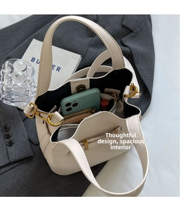 Interior view of white pebble leather bucket bag showing large capacity for essentials
