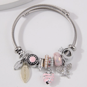 Silver steel beaded bracelet with pink heart and butterfly charms on light background