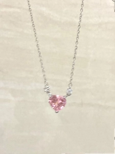 Detailed view of pink heart-shaped crystal pendant on a delicate silver-tone chain