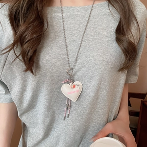 Detail of sweet heart pendant necklace with pink bow and silver bead chain