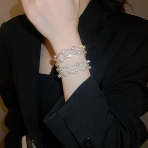 Close-up of luxury multi-layer pearl and rhinestone bracelet on model's wrist