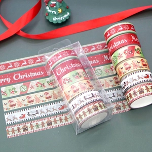 Close-up of 6-roll Christmas washi tape set featuring Santa and reindeer festive patterns