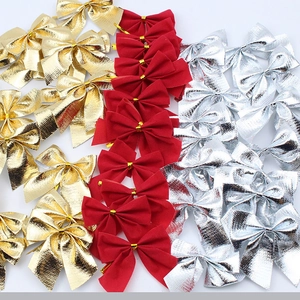 Flat lay of gold, red, and silver decorative Christmas bows for DIY crafts and trees