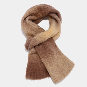 Detailed knit texture of gradient tie-dye scarf in warm earth tones for winter style