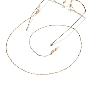 Minimalist gold eyeglass chain with spiral design and anti-slip rubber loops on white background