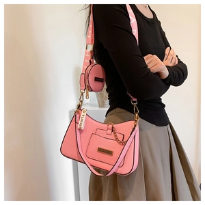 Detailed close-up of pink hobo bag set with litchi grain texture and brand logo