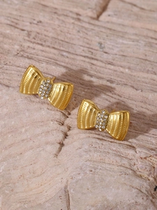 Detailed macro view of 18K gold plated bow earrings with sparkling zircon inlay