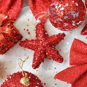 Red glitter Christmas ornaments set with star and gift ball shapes on white snow