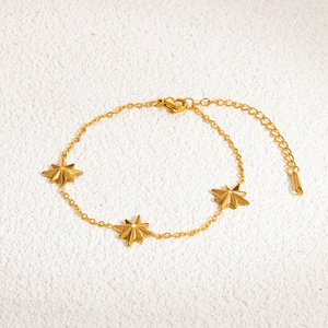 Detail of 18K gold plated stainless steel bracelet featuring three star charms and lobster clasp