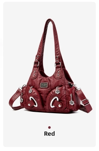 Detail of dark red PU leather tote with multi-pocket design and silver flower charm