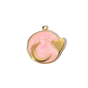 Detail of gold-plated pink resin moon and heart pendant with pearlescent shimmer finish