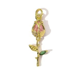 Detail of a gold rose pendant featuring a pink gemstone bud and green leaf stone