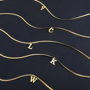 Five gold stainless steel snake chains with F, C, L, K, W initial pendants set