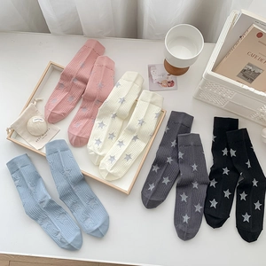 Five pairs of cotton crew socks with star patterns in pink, white, blue, grey, and black