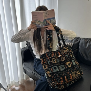 Cozy plush tote bag with geometric patterns held by a model in a modern home setting