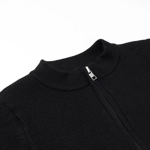 Detail view of the black ribbed knit fabric and silver half-zip collar on a jumpsuit
