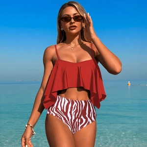 Detail of red ruffle bikini top and high-waisted zebra print bottoms on beach