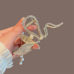 Luxurious gold mermaid hair claw clip with rhinestones and pearl tassel detail