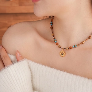 Titanium steel sun pendant necklace with natural stone beads on a fashion model