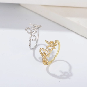Macro shot of Baby letter rings in gold and silver with shimmering micro zircons