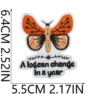 Detailed butterfly embroidery patch with 'A lot can change in a year' quote text