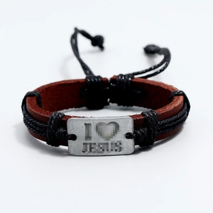 Detail view of woven leather bracelet featuring an engraved I Heart Jesus metal plate