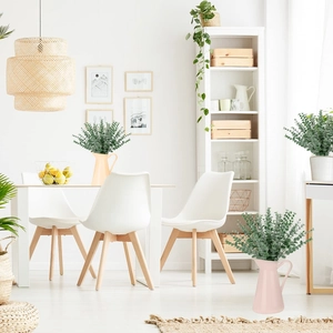 Artificial green eucalyptus stems displayed in minimalist ceramic vases for home decor