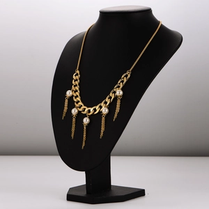 Exquisite golden NK chain necklace with pearls and tassels on a black display model