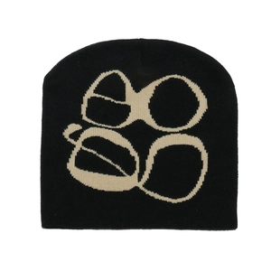 Close-up of gothic jacquard knit texture and beige pattern on black Y2K beanie