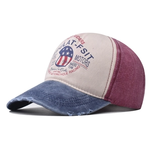 Detail of vintage washed baseball cap with motors embroidery and distressed brim edge