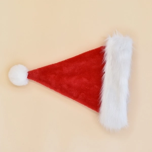 Flat lay of a plush red and white Christmas hat with soft fur trim on beige background