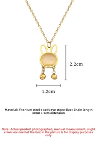 Detail of opal rabbit pendant in titanium steel with 2.2cm height and bell accents