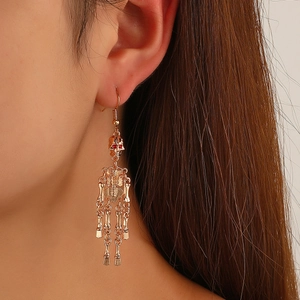Gothic gold skeleton drop earrings with punk style hollow design on female model