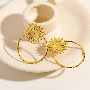 14K gold plated sunflower hoop earrings with hand-crafted texture on ceramic tray