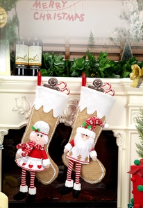 Detail of Christmas stocking set with 3D Santa and snowman on a cozy fireplace mantle