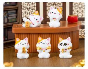 Detailed close-up of five mini resin fortune cats on a miniature wooden counter