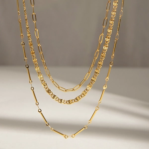 Three-layer stacked gold stainless steel necklaces with varied chain designs for women