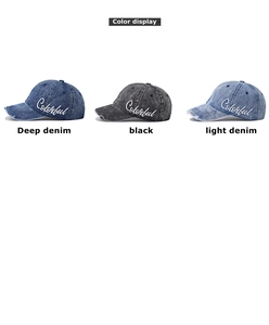 Detail view of washed denim baseball caps with embroidery and distressed edges in three colors