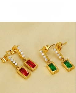 Detail of gold square earrings with red and green zircon stones and small white pearls