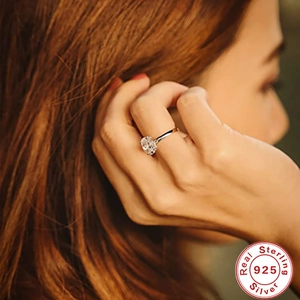 S925 sterling silver engagement ring with oval-cut cubic zirconia worn on a finger
